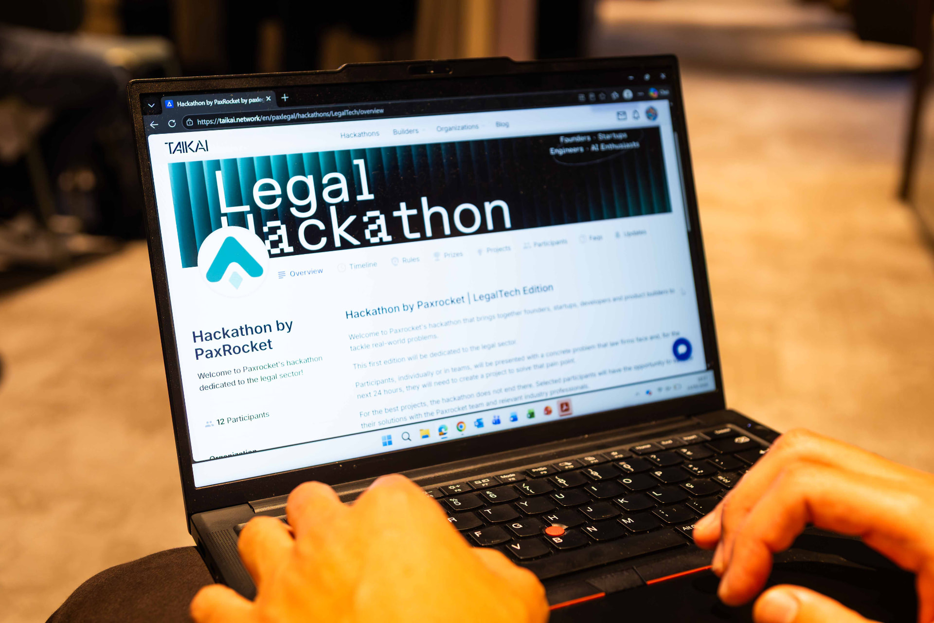 Participant working on the hackathon platform on a laptop during the LegalTech Hackathon at PaxRocket.
